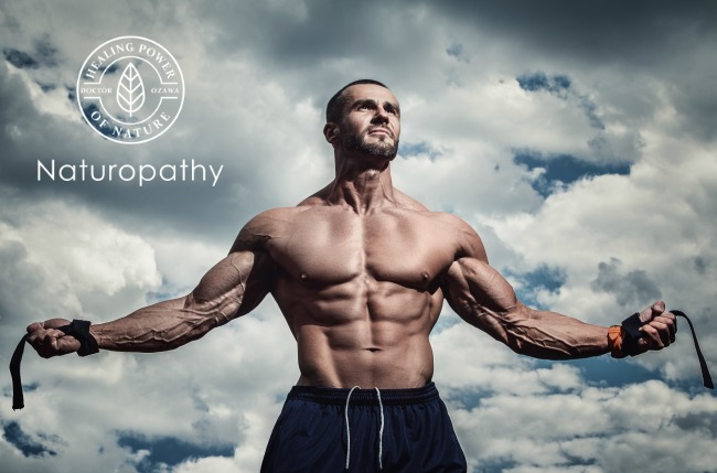 Muscular man posing under cloudy sky